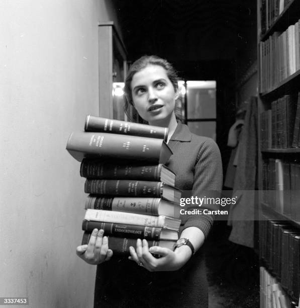 Student at Sarah Lawrence College in New York, with a pile of books.