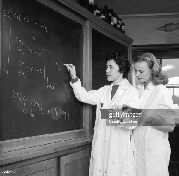 Alice Kandell and Sandra Edelson work on a equation during a chemistry class at Sarah Lawrence College, New York.