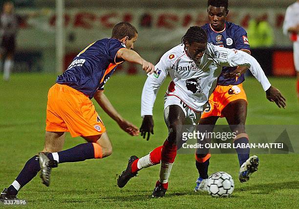 Ajaccio's Malian forward Mamadou Bagayoko controls the ball despite Montpellier's players Cameroonese midfielder Valery Mezague and Defender Bruno...