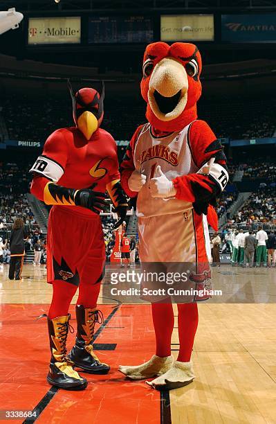 Atlanta Hawks mascots SkyHawk and Harry The Hawk display armbands in honor of The Coyote, mascot for the San Antonio Spurs during the Atlanta Hawks...