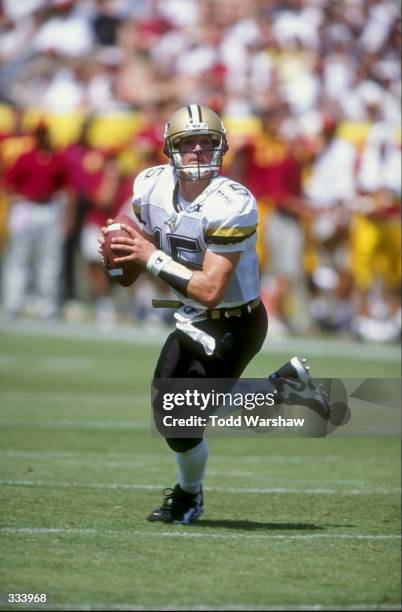Quarterback Drew Brees of the Purdue Boilermakers looks for an open receiver during the Pigskin Classic against the USC Trojans at the Memorial...