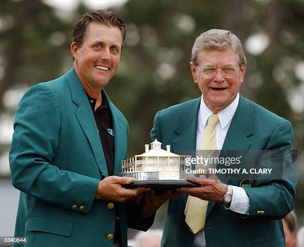 Phil Mickelson of the US receives trophy for winning the Masters Golf Tournament from Augusta National Chairman Hootie Johnson at the awards ceremony...