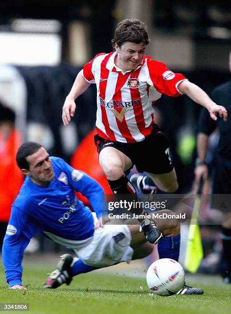 John Oster of Sunderland slips the tackle of Tommy Miller of Ipswich during the Nationwide Division One match between Ipswich Town and Sunderland at...