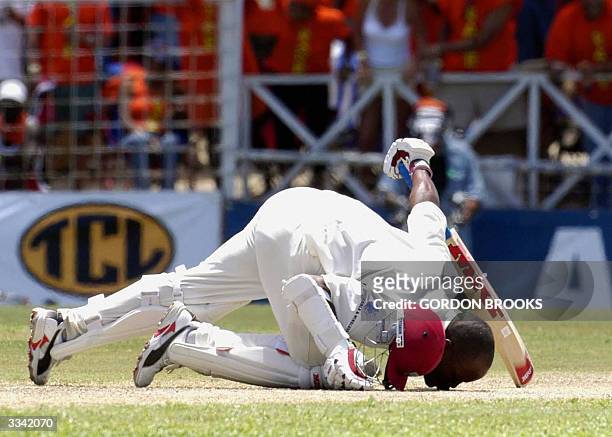 West Indies captain Brian Lara kisses the ground 12 April, 2004 in celebration of his record breaking 385 on the third day of the fourth and final...