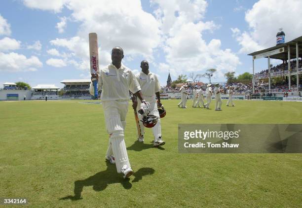 Brian Lara of the West Indies leaves the field after declaring his innings on 400 not out, the highest ever test score during day three of the 4th...