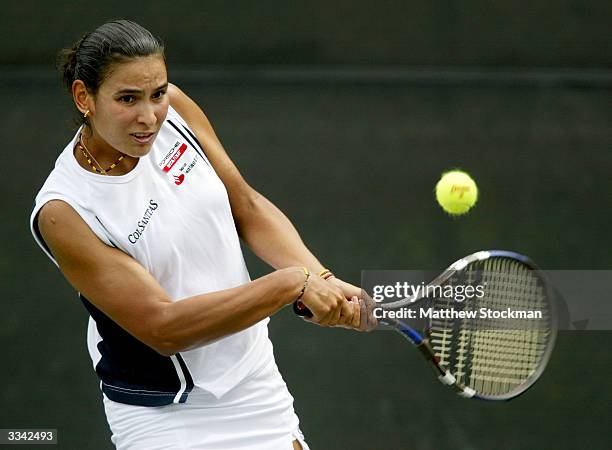 Fabiola Zuluaga of Columbia returns a shot to Marie-Gayanay Mikaelian of Switzerland during the Family Circle Cup on April 12, 2004 at the Family...