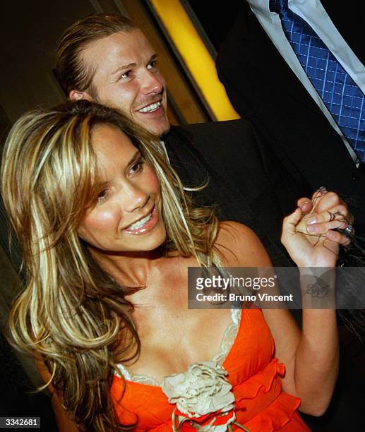 Real Madrid soccer player David Beckham and his wife, Victoria Beckham, leave Claridges Hotel April 12, 2004 in London, England.