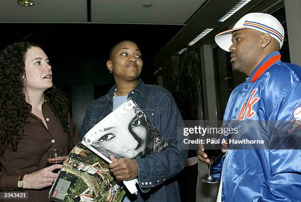 Lisa Hintelmann , Robyn Crawford and CEO of Roc-A-Fella Records/Rocawear Damon Dash look at a copy of Dash's new magazine "New America" during a...