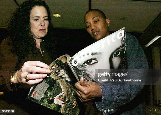 Lisa Hintelmann and Robyn Crawford look at a copy of Damon Dash's new magazine "New America" during a viewing of "Baadasssss!" at the Sony Screening...