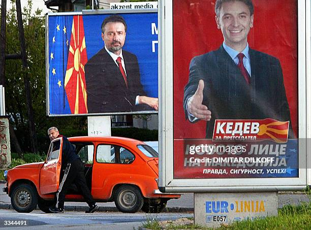 Man pushes his broken down Yugoslav made "Zastava" car between election posters for VMRO DPMNE, the main opposition party presidential candidate...