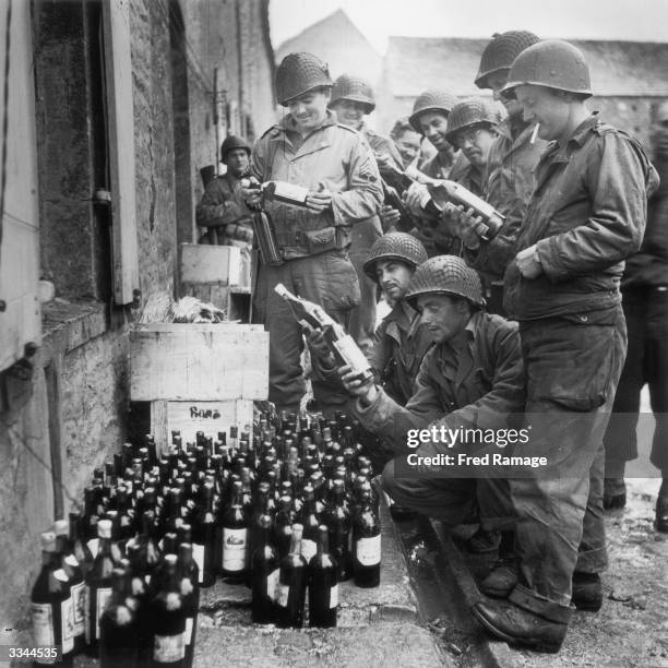 Troops of the American 4th Division find a store of wine left behind by retreating German forces in Cherbourg, France, 5th July 1944.