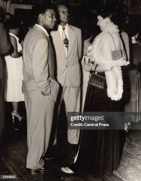 Lady Savage talking to cricketers everton Weekes and Faoud Bacchus, skipper of the East Indian Cricket Club, during a cocktail party hosted by the...
