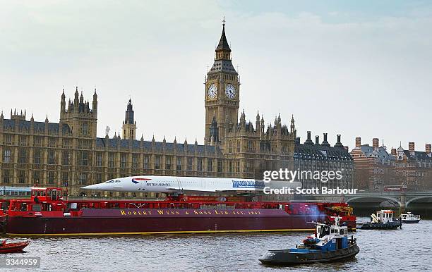 The last decommissioned Concorde sails down the River Thames, and past Britain's Houses of Parliament, on April 13, 2004 in London, England. The...