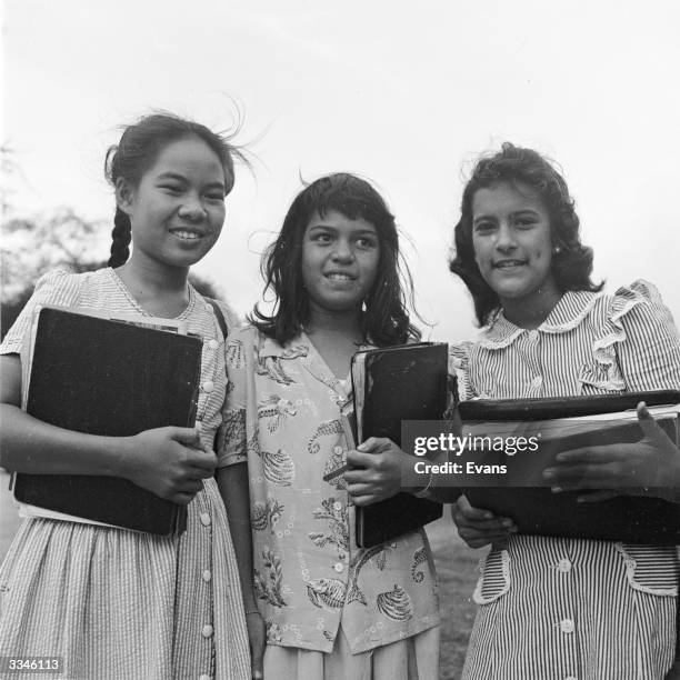 Three girls at Kamehameha Prep School, a school that takes only children of Hawaiian descent. Evident in their faces is the great range of ethnic...