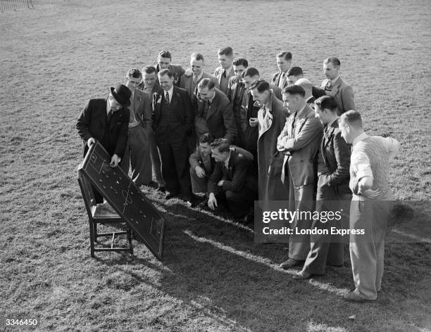 Ipswich Town football club players have a meeting to discuss tactics.