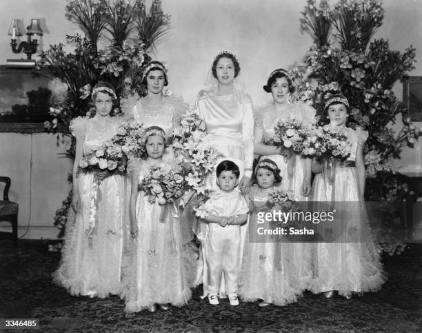 Miss Hester Irene Copper with her bridesmaids on her wedding day. Miss Copper will marry Colin Charles Rutherford. Bridesmaids are Betty Pais, Joy...
