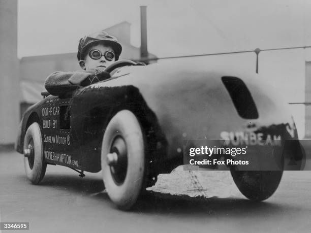 Boy in a pedal-car.