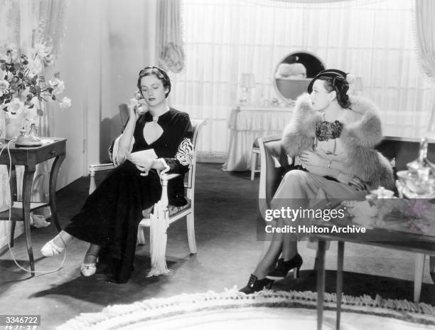 American film actress Marsha Hunt sitting in a lounge with Scottish film actress Frieda Inescort in a scene from 'Hollywood Boulevard', a Paramount...