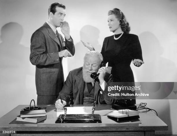 Irish actress Maureen O'Hara with American actor John Payne in a scene from 'Miracle on 34th Street' . Edmund Gwenn plays the lovable Kris Kringle.