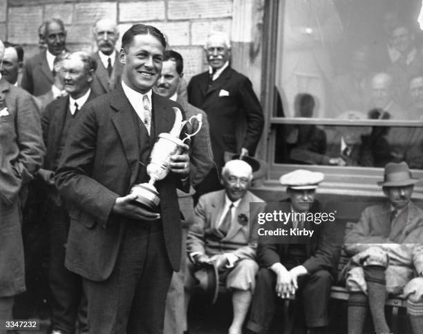 Bobby Jones holding his trophy having won the British Open at St Andrews with a record score of 285. Jones won the British Open three times and the...
