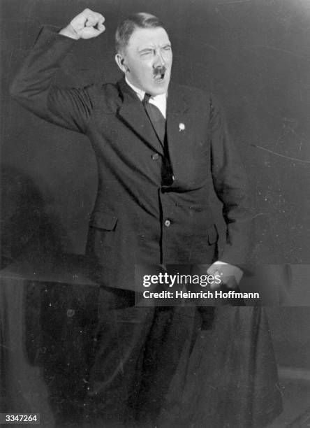 Hitler posing to a recording of one of his speeches after his release from Landsberg Prison.