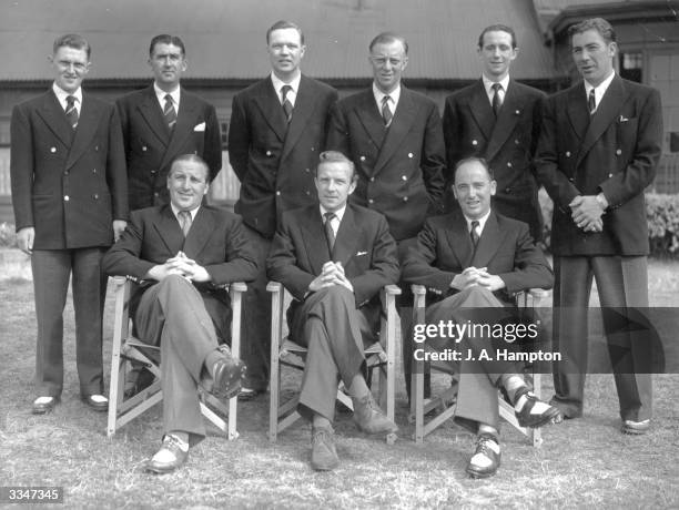 The British Walker Cup team wearing their team uniform which consist of a double breasted blazer with gilt buttons and grey flannels. Standing left...