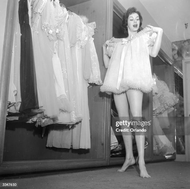 Jane, a model and tester of lingerie for Beaumond Lingerie in New York, is clearly happy with a small nightie chosen from a collection of...