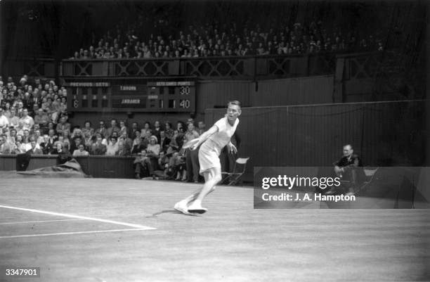 American tennis player Jack Kramer in action on his way to beating fellow American Tom Brown in the men's singles final at Wimbledon.