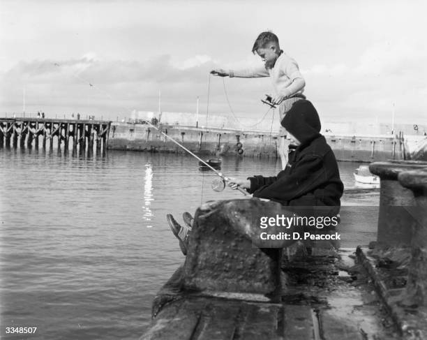 Two boys fishing at the harbour at Bangor in County Down.