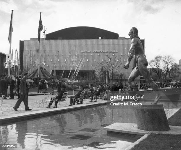Nude sculpture by Jacob Epstein stands above a pool beside the Royal Festival Hall on London's South Bank, venue of the Festival of Britain.