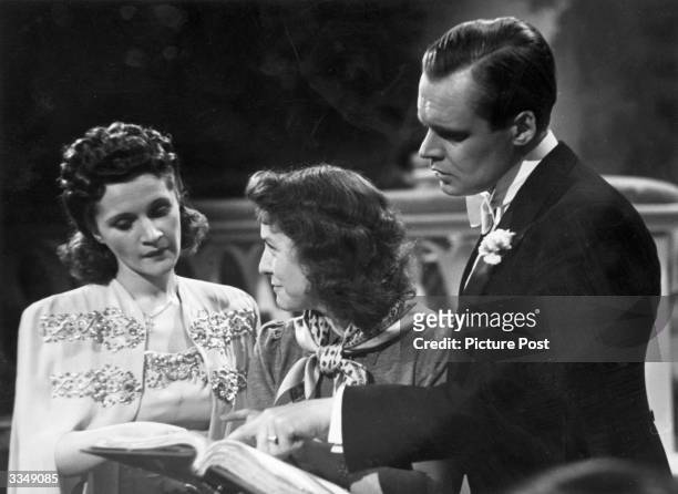Actress and former dancer Barbara Mullen and German actor Albert Lieven read through the script again before filming a scene for 'Jeannie', a comedy...