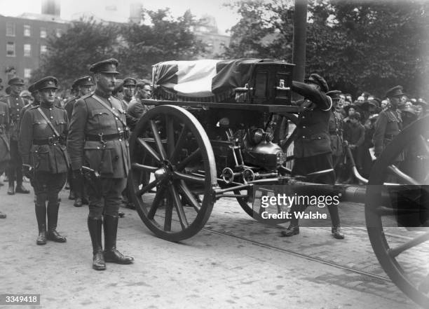 The Irish tricolour is placed on the coffin of the soldier, politician and Sinn Fein leader Michael Collins at his funeral in Dublin. Collins was...