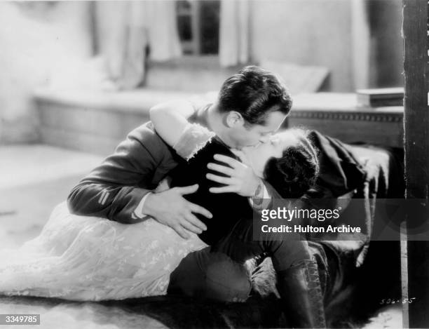 June Walker and Robert Montgomery enact a passionate screen kiss for the MGM film 'War Nurse', set during World War I.