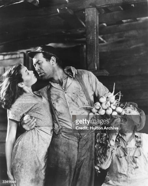 Gene Tierney as Elle May Lester and Ward Bond as Lov Bensey in the film, 'Tobacco Road' directed by John Ford and produced by 20th Century Fox.