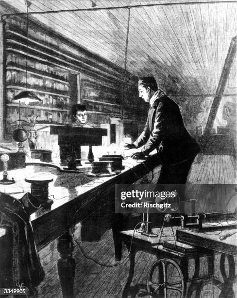 American inventor Thomas Edison works on the electric light bulb in his laboratory.