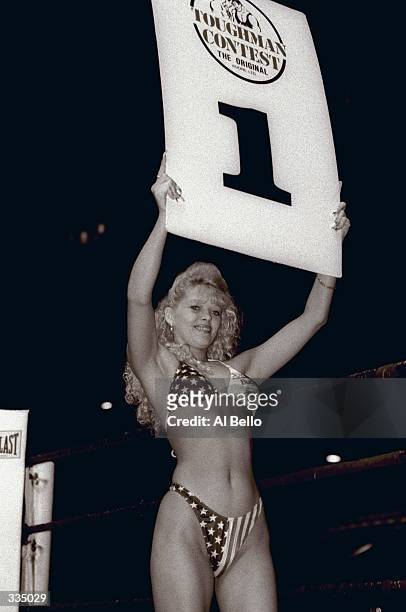 General view of a ring girl holding a placard to announce the first round of competition during the Toughman Contest in Kalamazoo, Michigan....