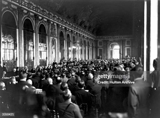 Diplomats and delegates watching the signing of the Peace Treaty of Versailles in the Hall of Mirrors at Versailles in France.