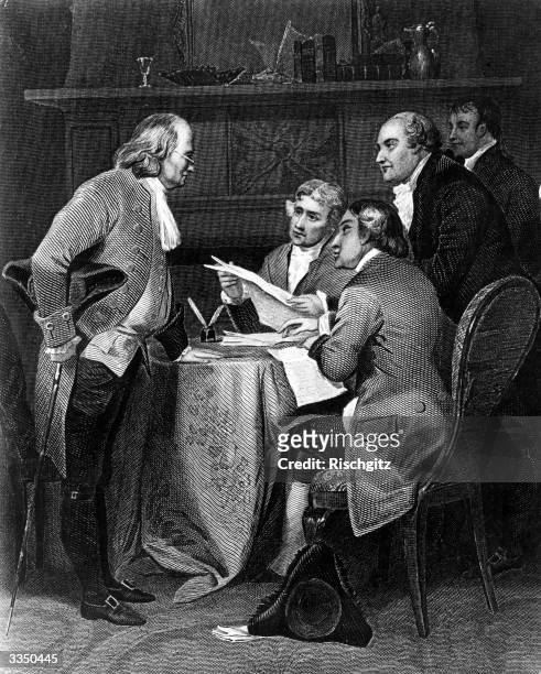 Benjamin Franklin , American politician, writer and inventor, drafting the Declaration of Independence. The drafting committee includes future...