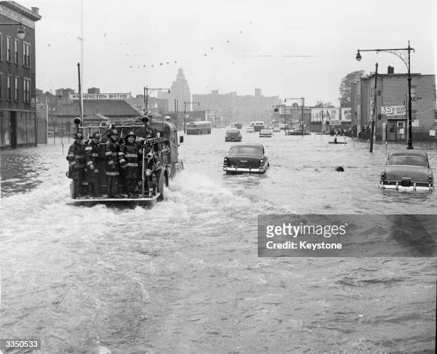 Fire tender being driven through a flooded street in New York street in the wake of Hurricane Donna in which 135 people lost their lives.