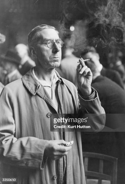 Smoker, E Slocombe, trying out a new blend of cigarette, made from British and American grown leaves, at the British Pioneer Tobacco growers'...
