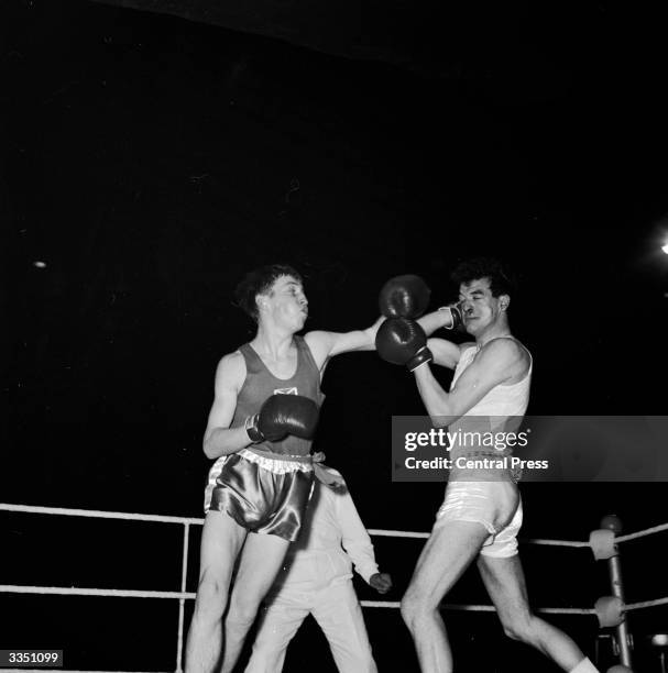 Ken Buchanan lands a hard left on the face of opponenet J Isaac during a bout at the ABA finals at Wembley stadium in London.