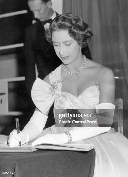 Princess Margaret signs the visitors book at the European School at Arusha in Tanganyika .