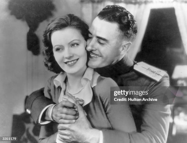 American actor John Gilbert embracing Swedish leading actress Greta Garbo in a scene from the MGM film 'Love'.