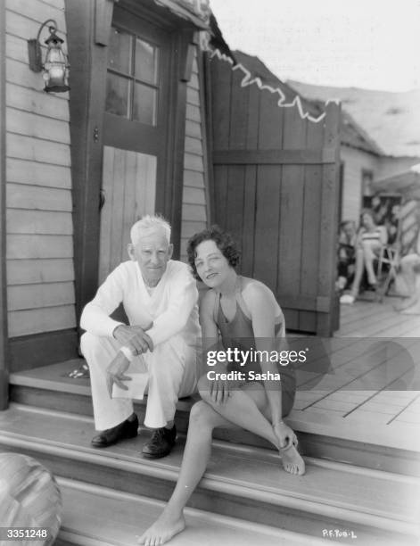 Silent film star Pauline Frederick on the steps of her beach bungalow with her agent Major Morris J Herbert.