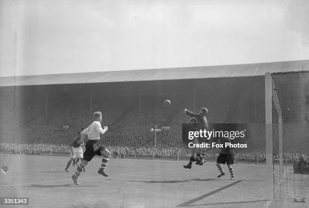 Sam Bartram, the Charlton Athletic goalkeeper, punches the ball clear, during the FA Cup Final between Charlton Athletic and Burnley at Wembley...