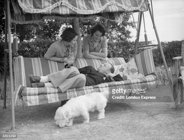 Australian cricketer Don Bradman with his wife and Mrs Robins at the Robins' house near Maidenhead, Berkshire in England. Sir Donald Bradman was the...