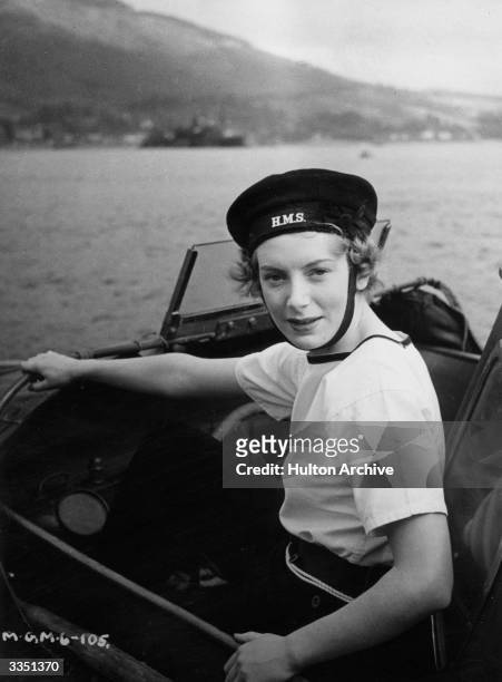 British actress Deborah Kerr in a naval launch on the set for the film 'Perfect Strangers', directed by Alexander Korda for London Films. Born...