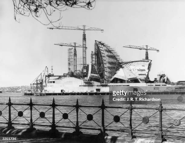 Construction of the shell-shaped roof of the new opera house in Sydney harbour, New South Wales. Designed by Danish architect Jorn Utzon and...