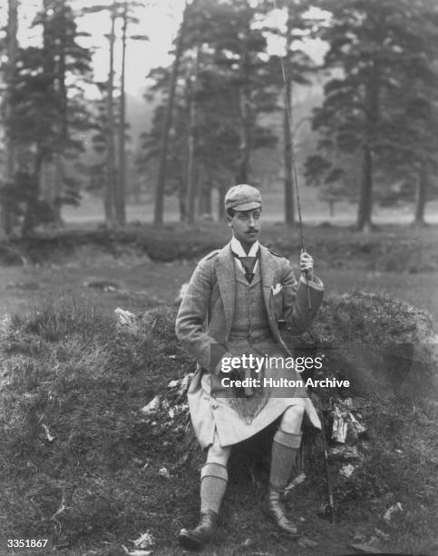 Prince Albert Victor , Duke of Clarence, wearing a kilt and sporran, holding a fishing rod.