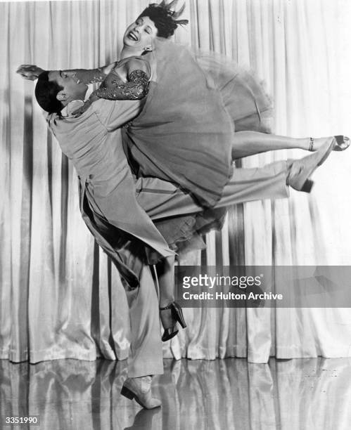 Dancing couple Tony and Sally De Marco perform a daring leap in the 20th Century Fox music and dance extravaganza 'Greenwich Village', directed by...